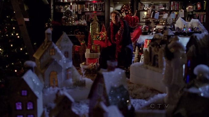 Richard Castle surrounded by Christmas decorations