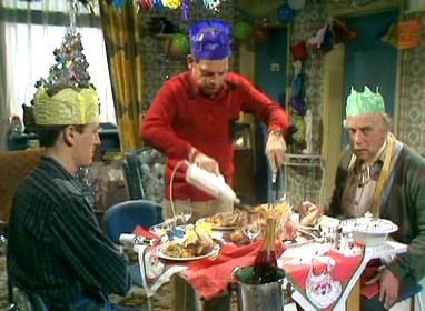 Scene from Christmas Crackers of Del Boy carving turkey for himself, Rodney and Grandad